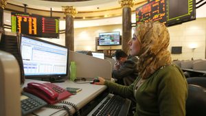 A trader works at the Egyptian Exchange. The rally on Egypt's bourse may continue if company valuations remain cheap